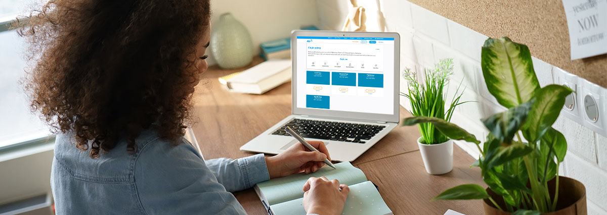 Students studying with past exam papers and study materials